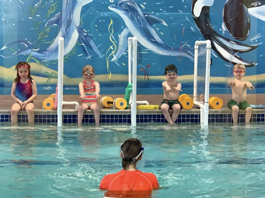 children participating in swim lesson